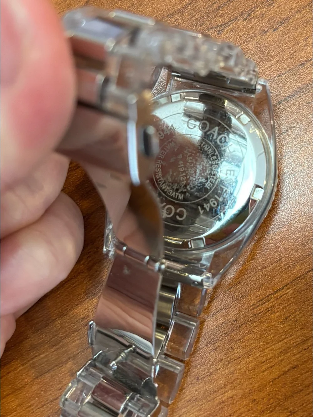 Coach women’s Silver Tone Watch with Black Dial and clear acrylic band